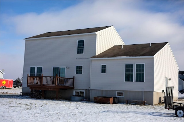 view of snow covered rear of property