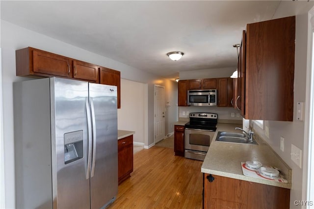 kitchen featuring sink, stainless steel appliances, and light hardwood / wood-style flooring