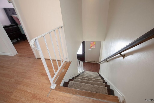 stairs with hardwood / wood-style flooring