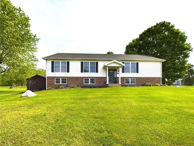 bi-level home featuring a shed and a front yard