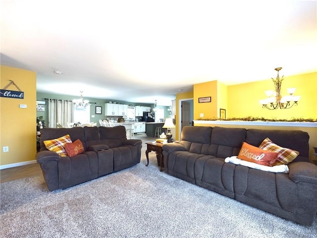 carpeted living room featuring a notable chandelier