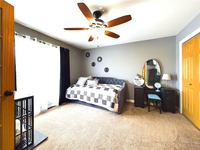 bedroom with ceiling fan, a closet, and carpet floors