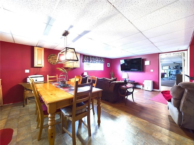 dining area with a paneled ceiling