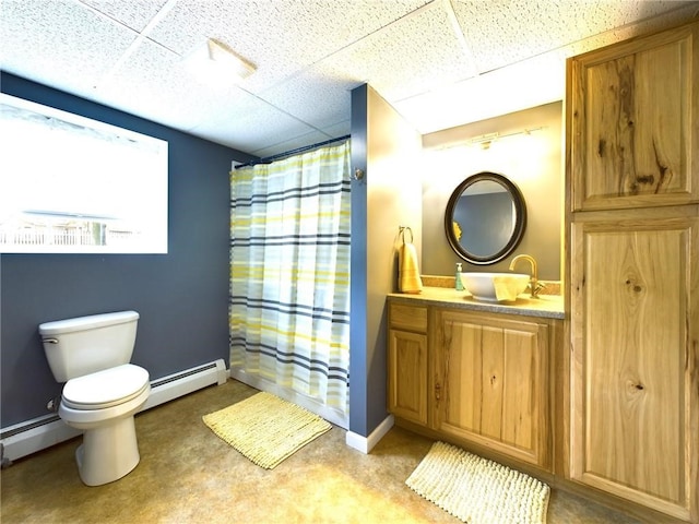 bathroom featuring baseboard heating, vanity, a paneled ceiling, and toilet