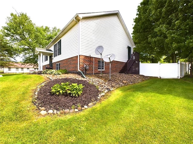 view of home's exterior with a yard