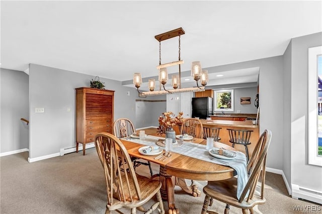 dining area featuring a baseboard heating unit, carpet floors, a baseboard radiator, and baseboards