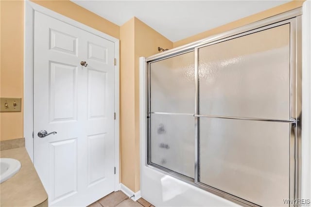 full bathroom featuring baseboards, enclosed tub / shower combo, vanity, and tile patterned floors