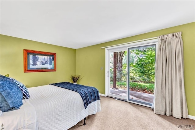 carpeted bedroom featuring access to outside and baseboards