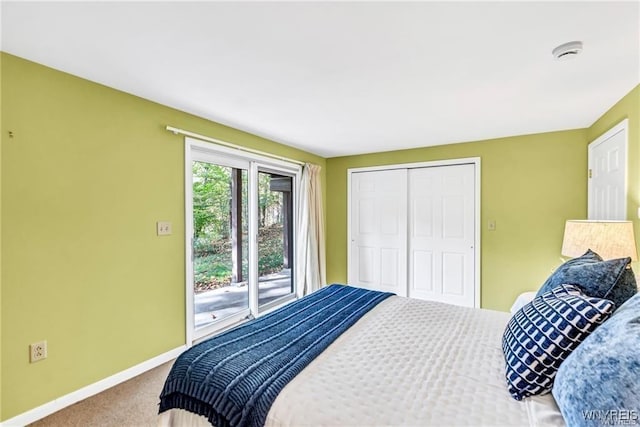 bedroom with a closet, carpet, and baseboards