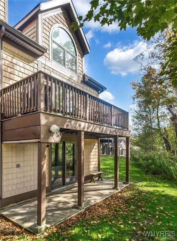 rear view of property featuring a patio area and a yard