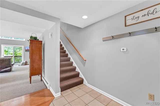 staircase featuring a baseboard heating unit, recessed lighting, tile patterned floors, and baseboards