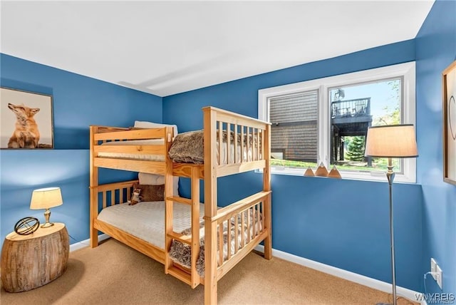 bedroom featuring carpet floors and baseboards