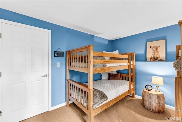 carpeted bedroom featuring baseboards