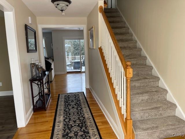 stairs featuring wood-type flooring