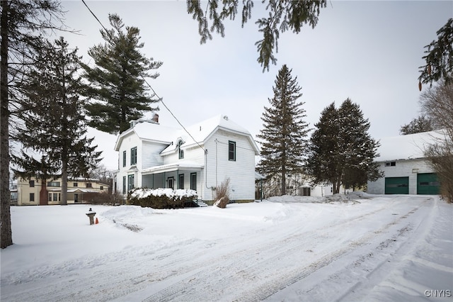 snow covered property with a porch