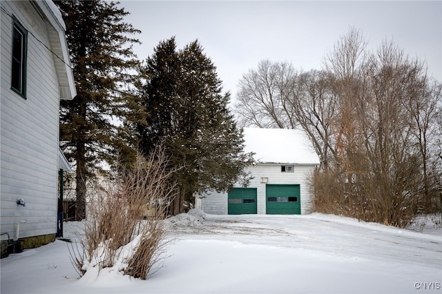 exterior space featuring a garage and an outbuilding