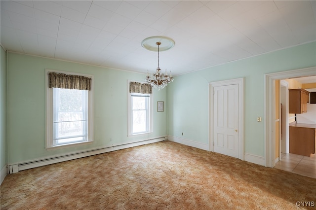 carpeted empty room featuring a chandelier and a baseboard heating unit