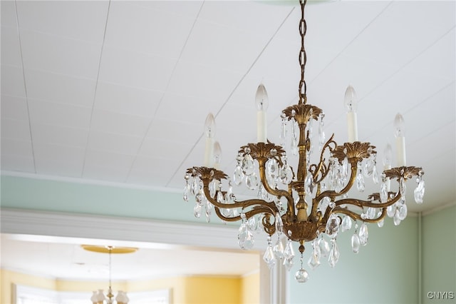 interior details featuring an inviting chandelier