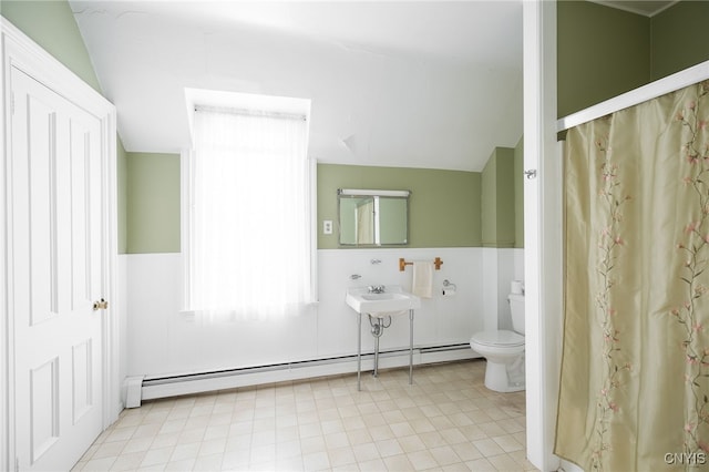 bathroom featuring toilet, lofted ceiling, sink, and a baseboard radiator