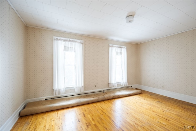 spare room with hardwood / wood-style floors and ornamental molding