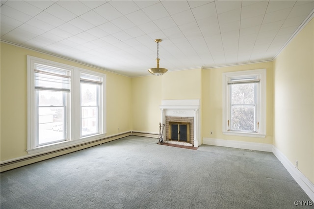 unfurnished living room with a wealth of natural light, ornamental molding, a baseboard heating unit, and a brick fireplace