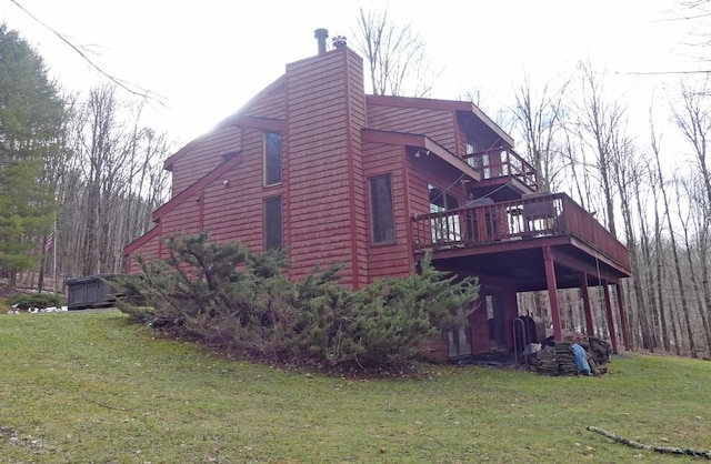 view of home's exterior with a wooden deck and a yard