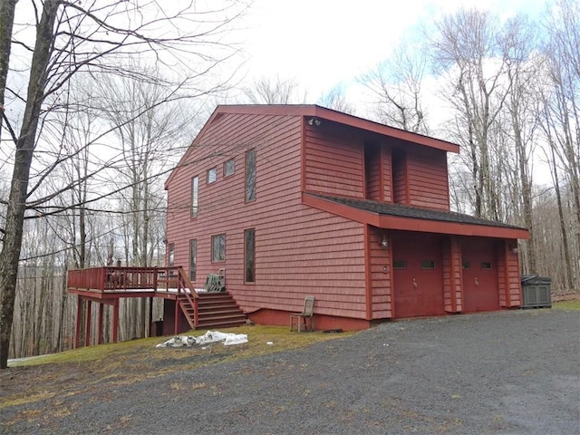 view of home's exterior with a deck and a garage