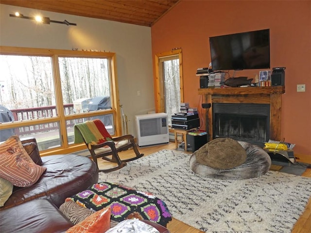 living room with vaulted ceiling, wood ceiling, and light hardwood / wood-style floors