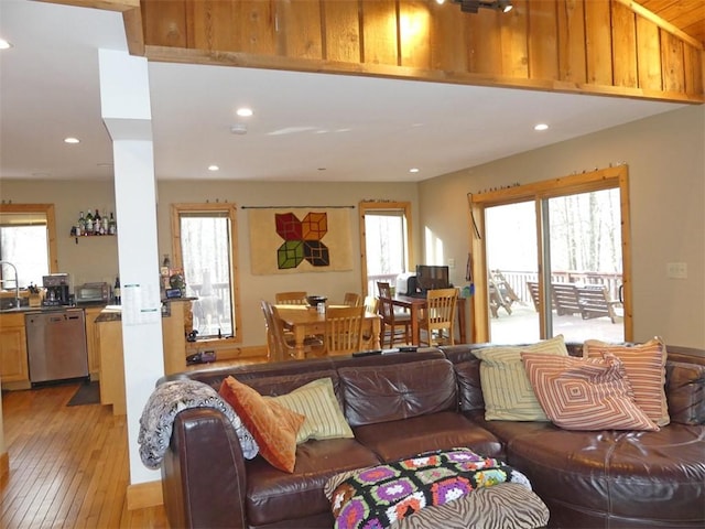 living room with sink and light hardwood / wood-style floors