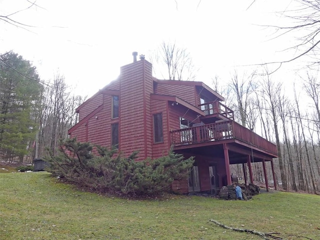 view of home's exterior with a lawn and a deck