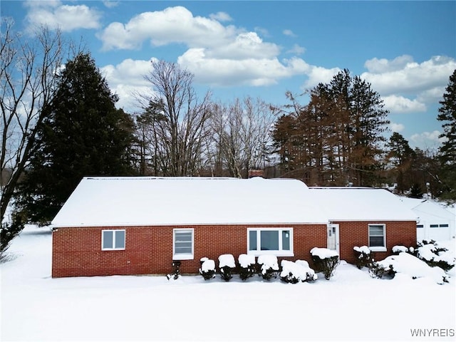 view of snow covered back of property