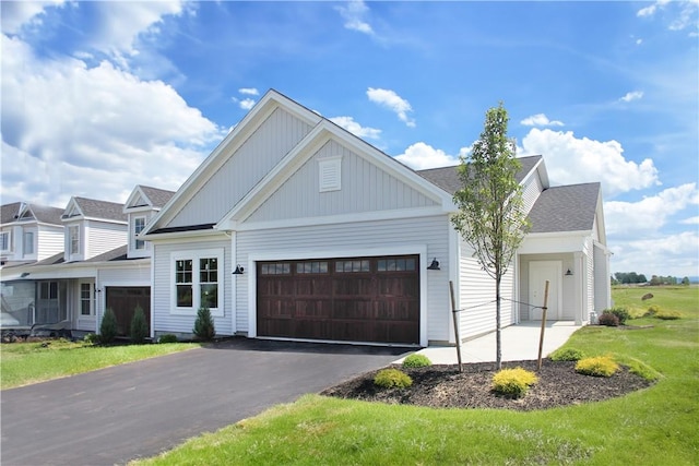 view of front of home featuring a garage and a front lawn