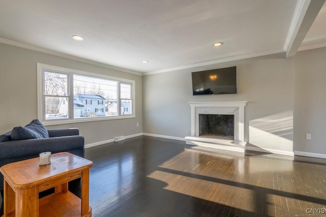 living room featuring dark hardwood / wood-style floors, crown molding, and a premium fireplace