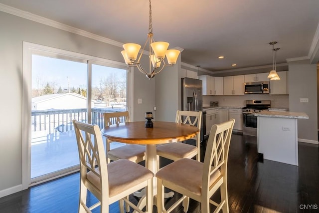 dining space featuring ornamental molding, dark wood-type flooring, and a notable chandelier