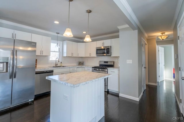 kitchen featuring white cabinetry, a center island, sink, decorative light fixtures, and appliances with stainless steel finishes