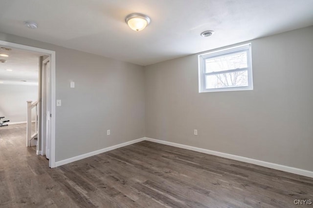 empty room with dark hardwood / wood-style flooring