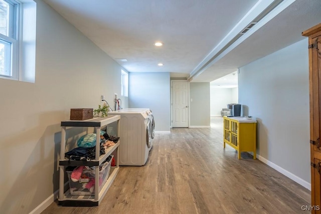 laundry room featuring wood-type flooring and washing machine and clothes dryer