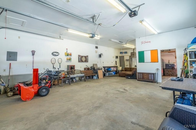 garage with electric panel and a garage door opener