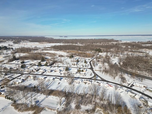 snowy aerial view with a water view