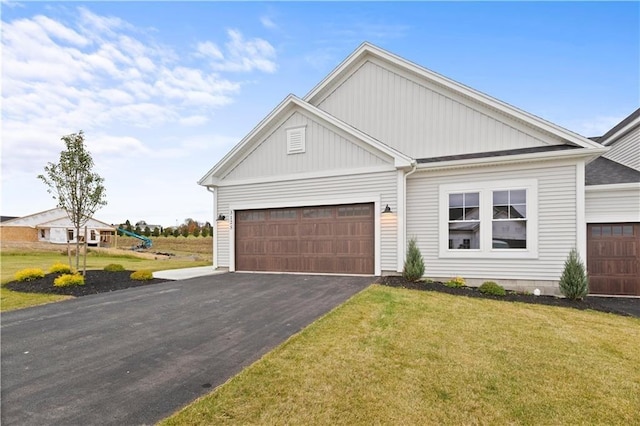 view of front of house with a garage and a front lawn