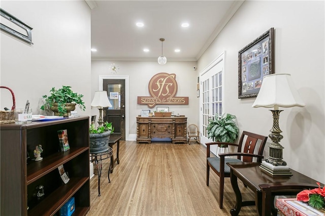 sitting room featuring light hardwood / wood-style floors and crown molding