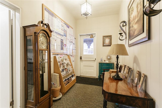 doorway to outside with dark carpet