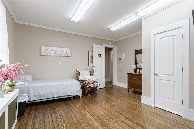 bedroom with hardwood / wood-style floors and ornamental molding