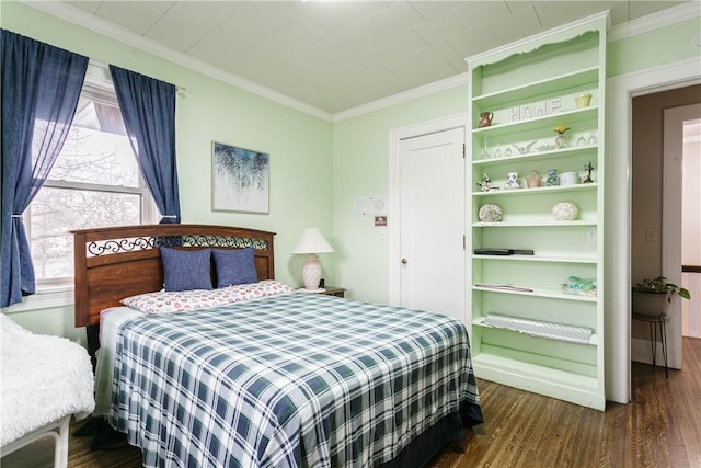 bedroom with dark wood-type flooring and ornamental molding