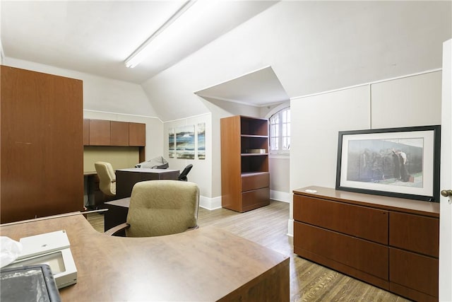 office space with light hardwood / wood-style flooring and lofted ceiling