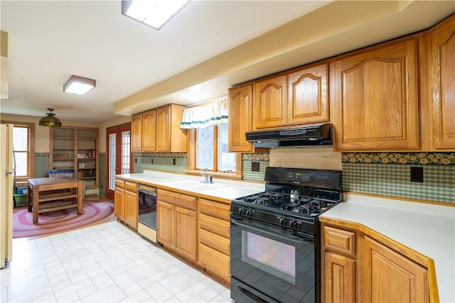 kitchen with tasteful backsplash, a wealth of natural light, sink, and black appliances