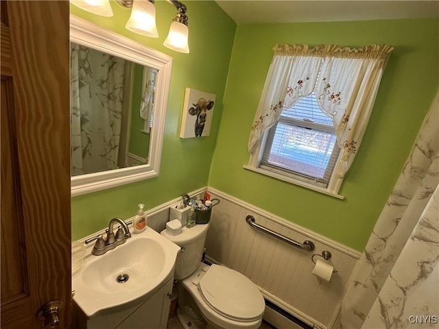 bathroom with vanity, toilet, and a baseboard radiator