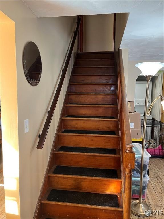 stairway with hardwood / wood-style flooring