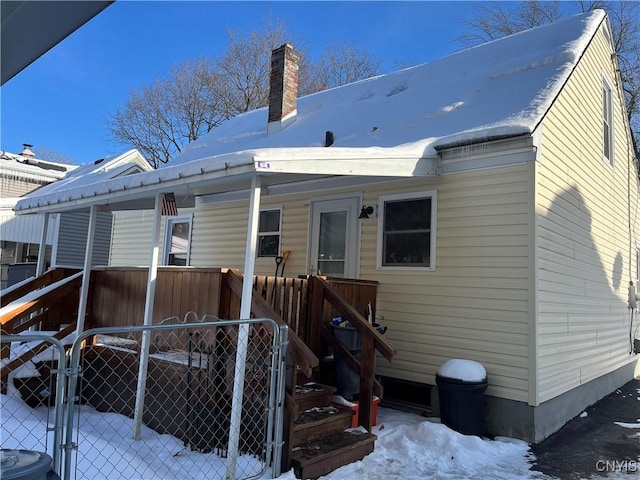 view of snow covered rear of property