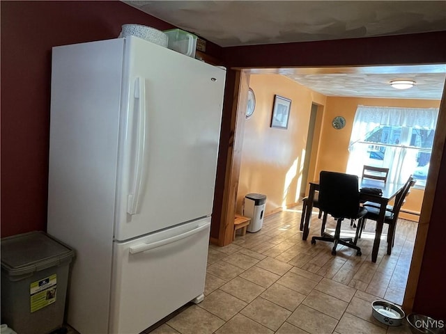 kitchen with white fridge and light tile patterned flooring